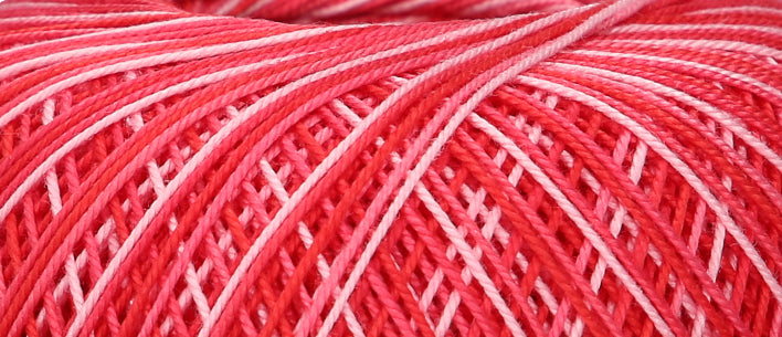 Ball of variegated red Puppets Eldorado cotton crochet thread