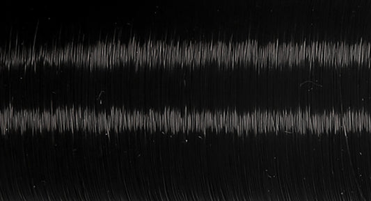 Spool of dark translucent Coats Invisible thread