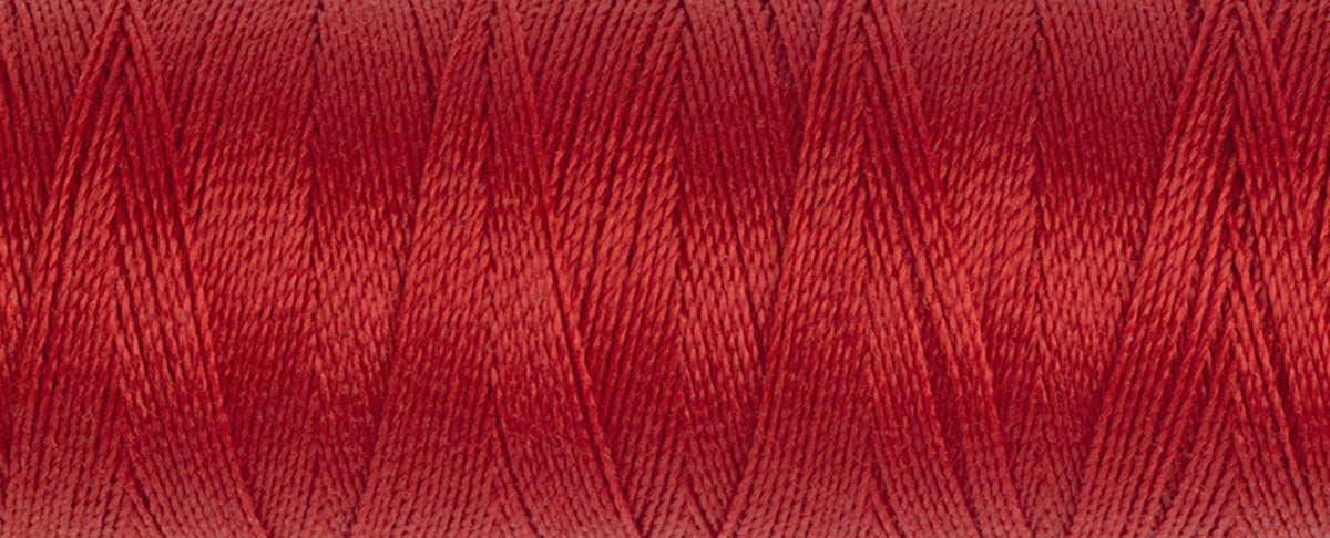 Spool of Gutermann Maraflex elastic thread in brick red