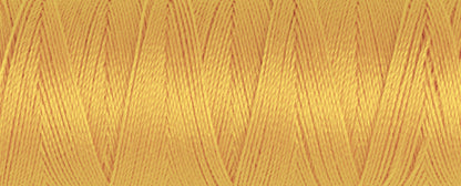 Spool of honey Gutermann Maraflex elastic sewing thread