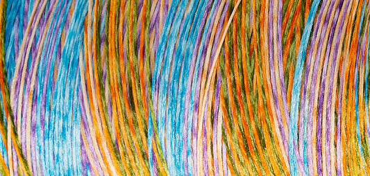 Madeira Aeroflock textured overlock thread on a mini king spool in opal