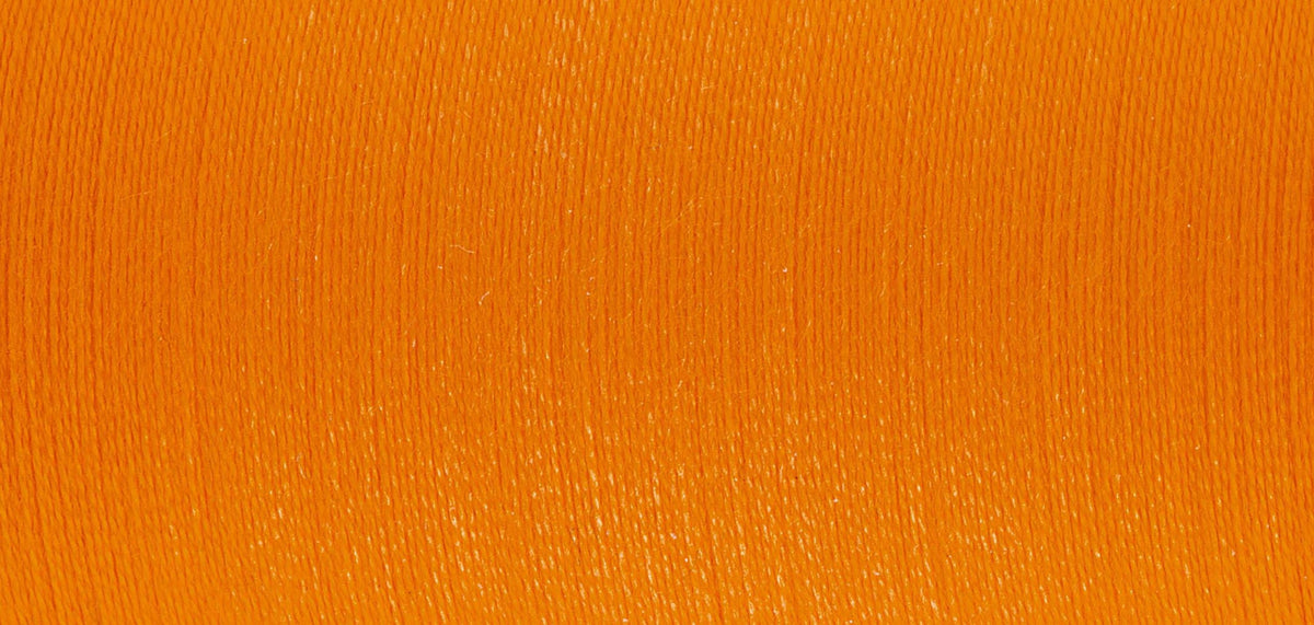 Spool of Madeira Sensa Green embroidery thread in sunset