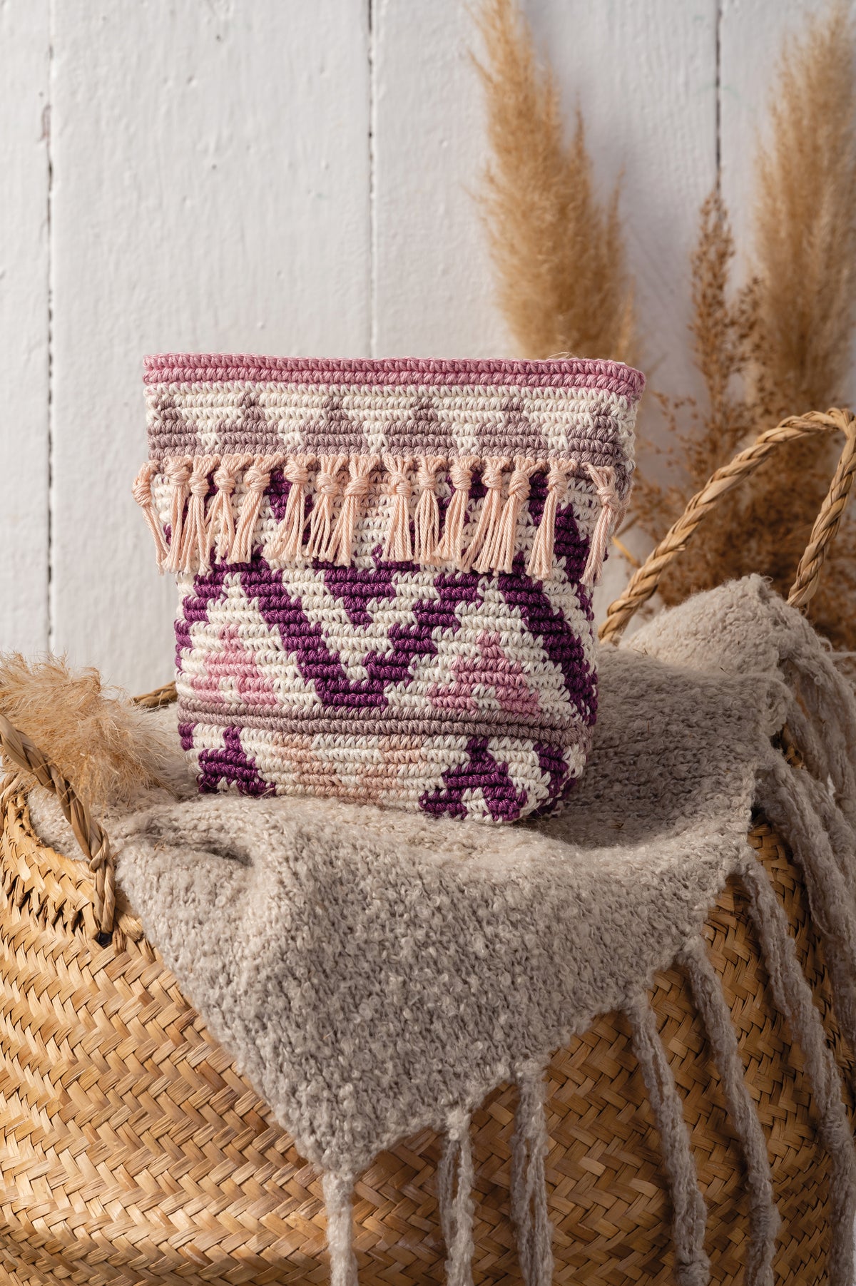 Crocheted boho zip pouch in bougainville colours from the Anchor kit