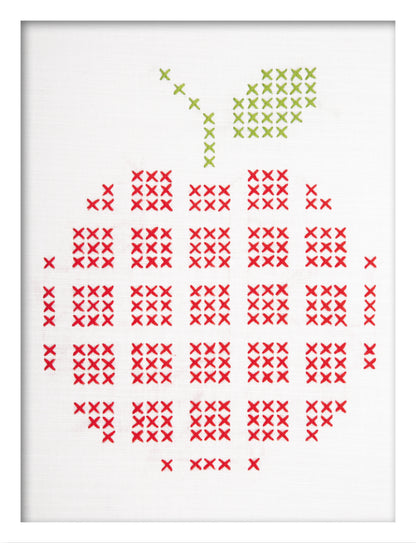 Embroidered apple design on white fabric