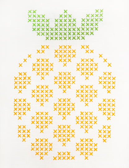 Embroidered pineapple design on white fabric