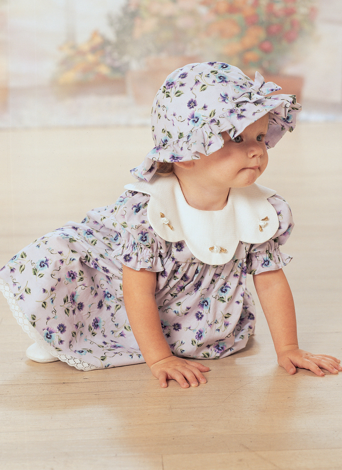 Butterick B4110 sewing pattern envelope showing the baby dress & jumpsuit designs