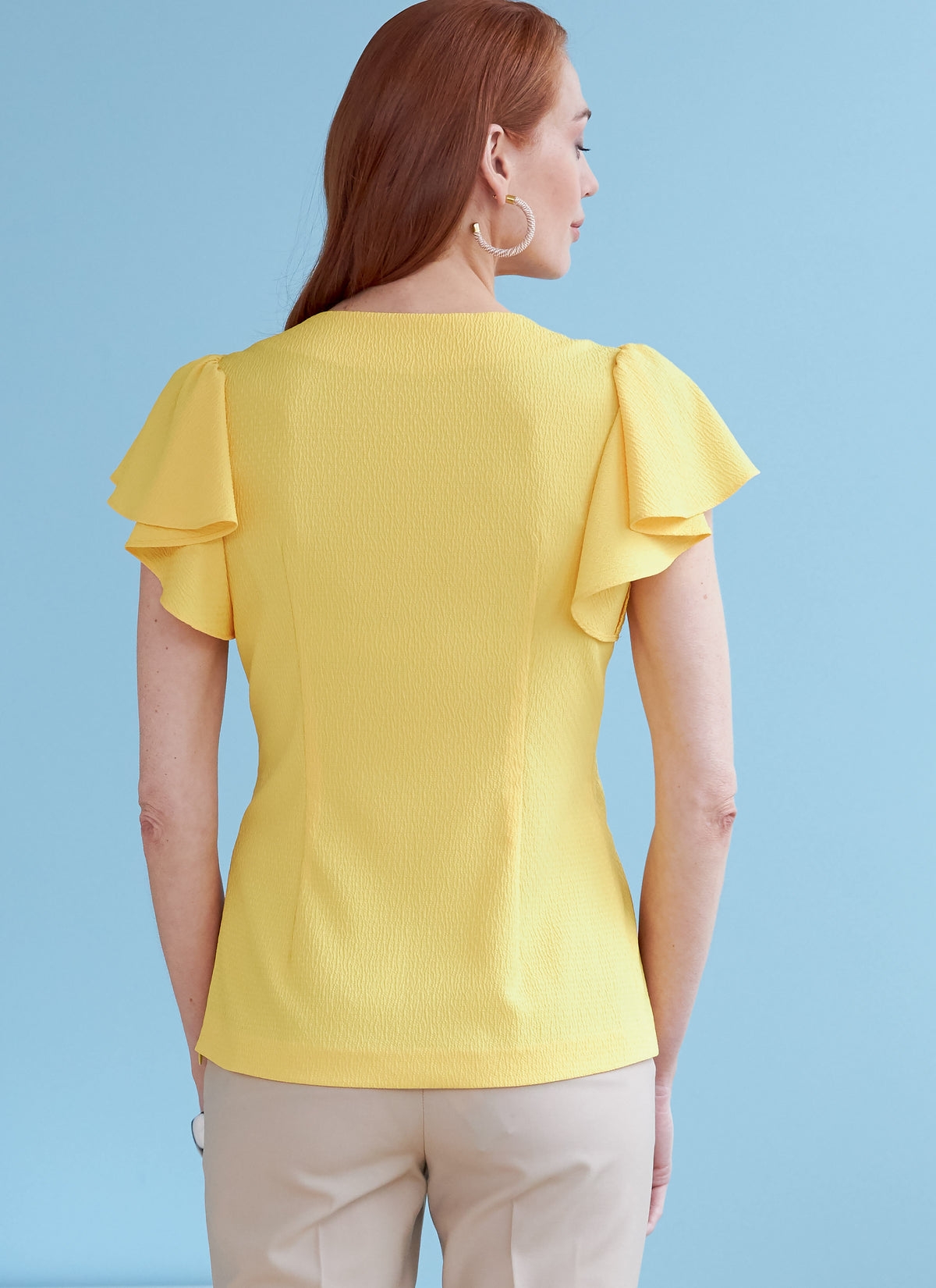 Butterick B6731 sewing pattern envelope showing V-neck tops with front ties