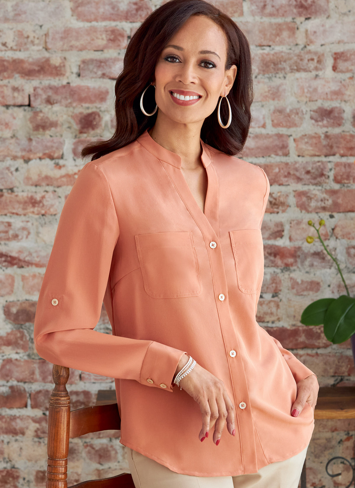 Butterick B6856 sewing pattern envelope showing women's button front top with pockets designs