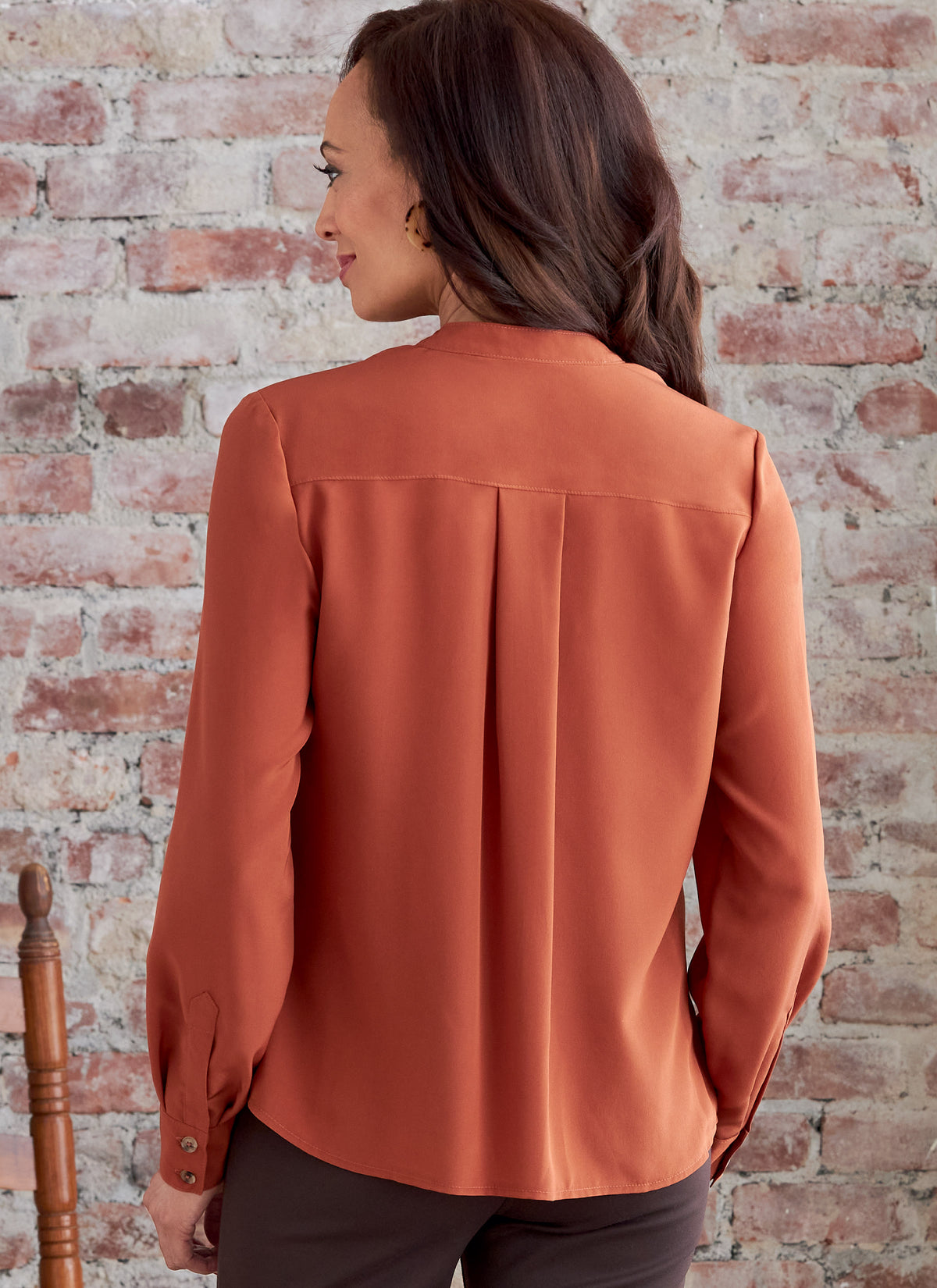 Butterick B6856 sewing pattern envelope showing women's button front top with pockets designs