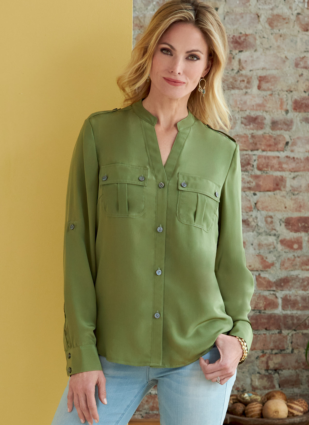Butterick B6856 sewing pattern envelope showing women's button front top with pockets designs
