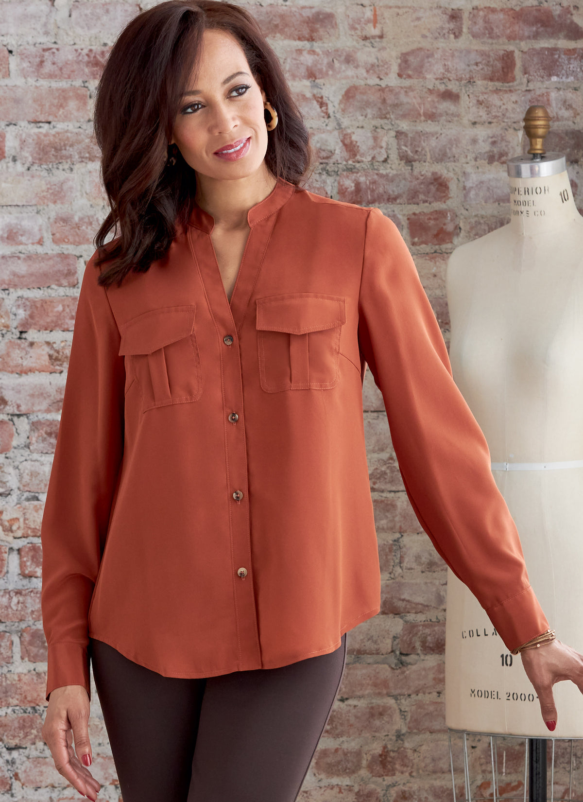 Butterick B6856 sewing pattern envelope showing women's button front top with pockets designs
