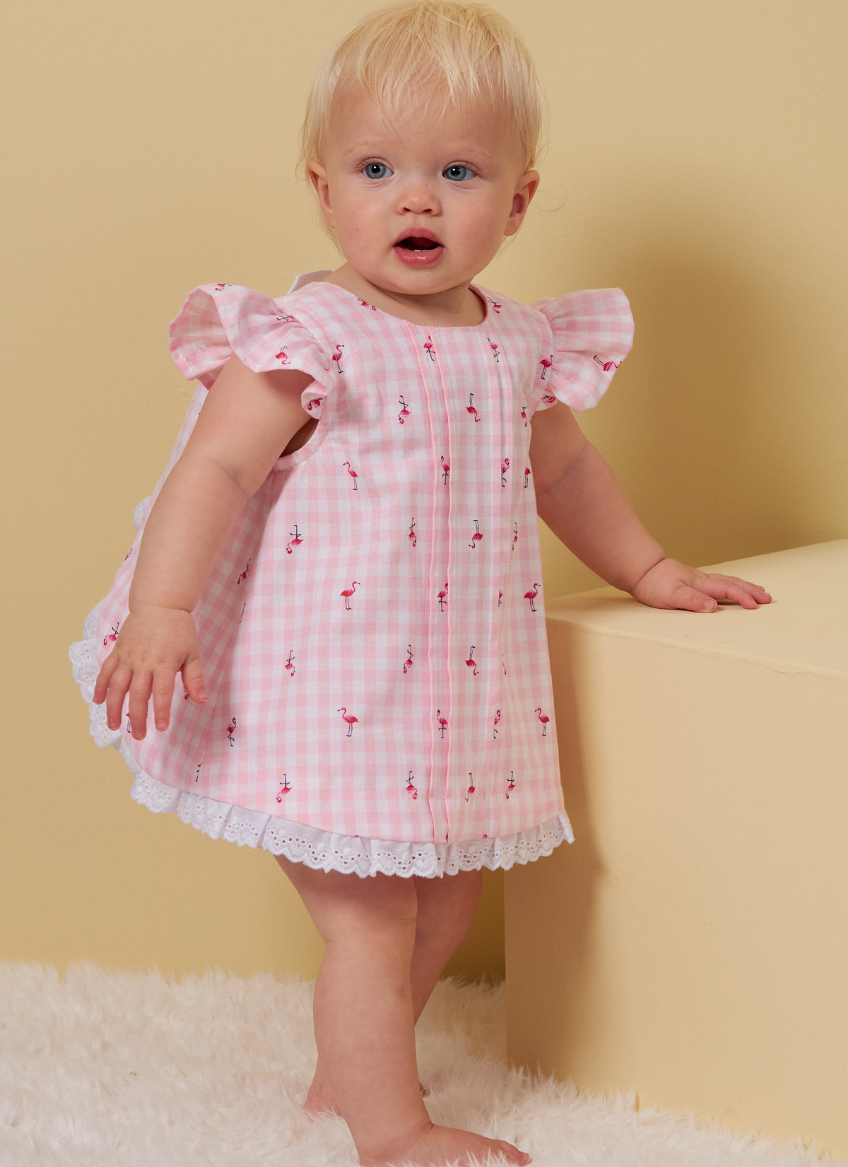 Butterick B6884 sewing pattern envelope showing baby a-line top designs