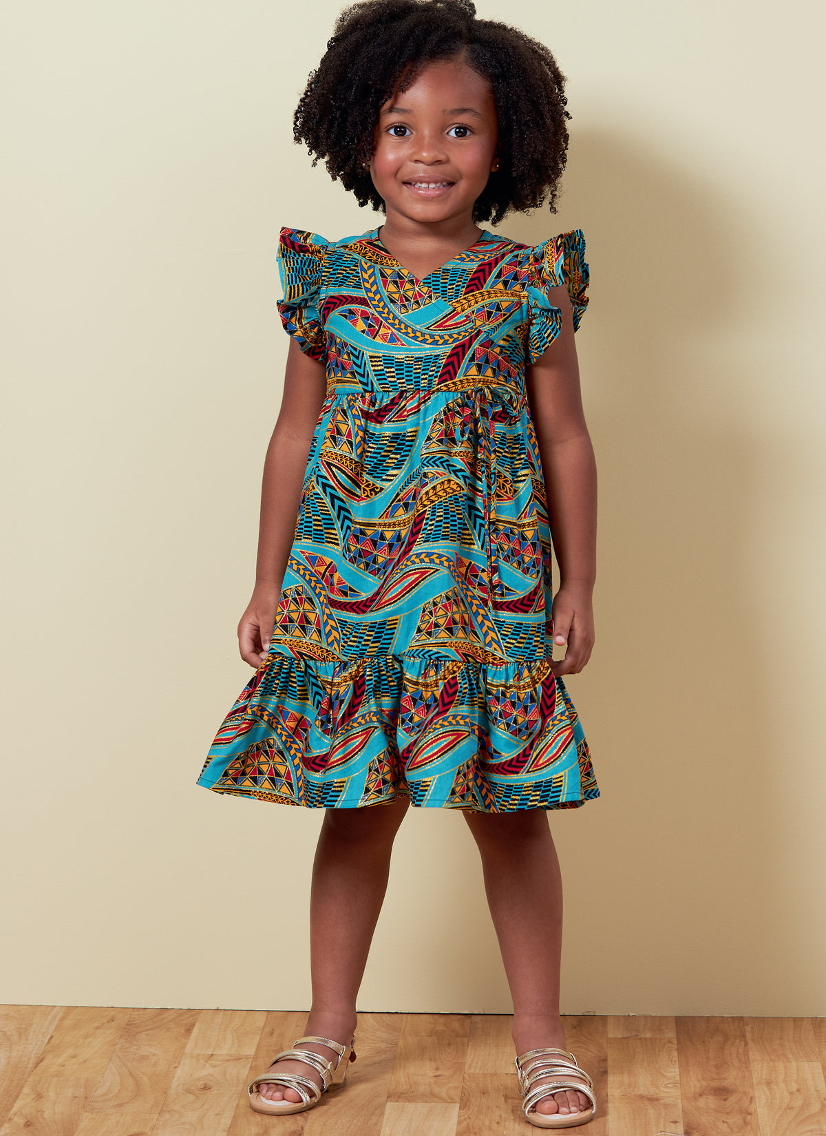 Butterick B6887 sewing pattern envelope showing children's faux wrap dress designs