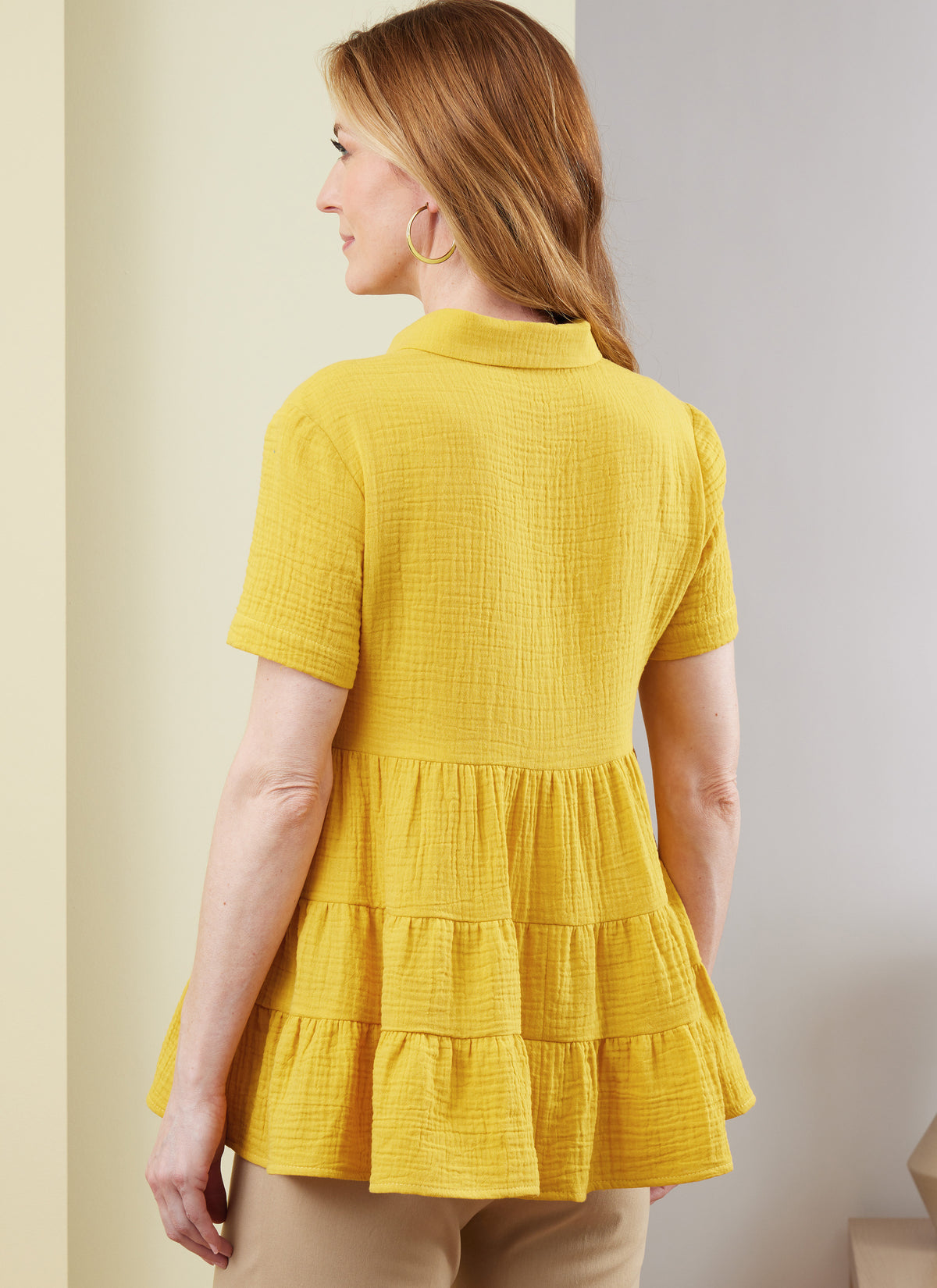 Butterick B6897 sewing pattern envelope showing misses' tiered button front top designs