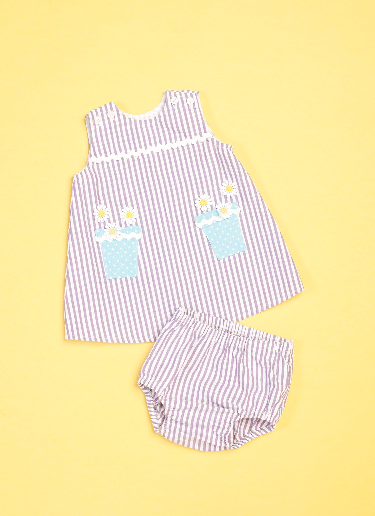 Butterick B6905 sewing pattern envelope showing the baby overalls, dress and knickers designs