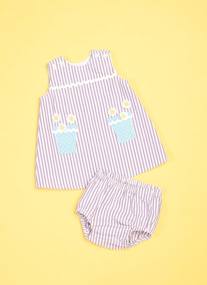 Butterick B6905 sewing pattern envelope showing the baby overalls, dress and knickers designs