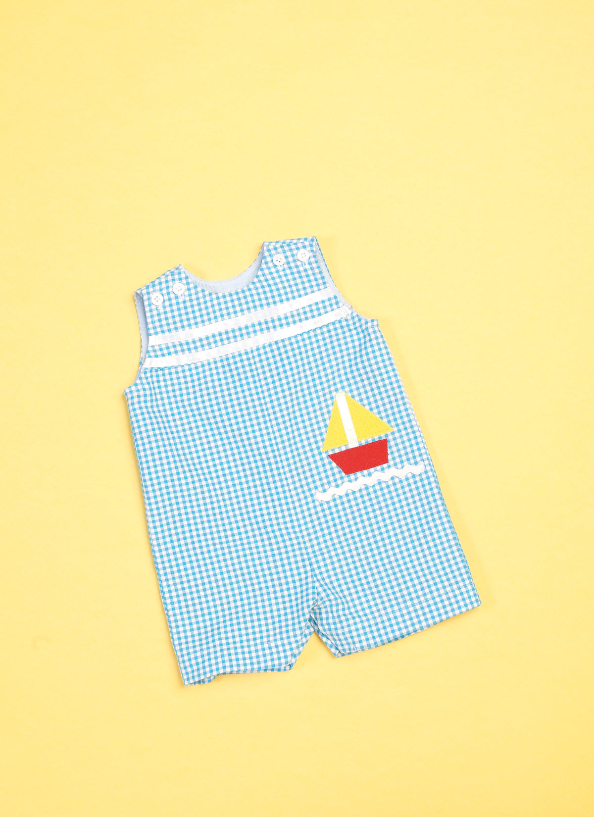 Butterick B6905 sewing pattern envelope showing the baby overalls, dress and knickers designs