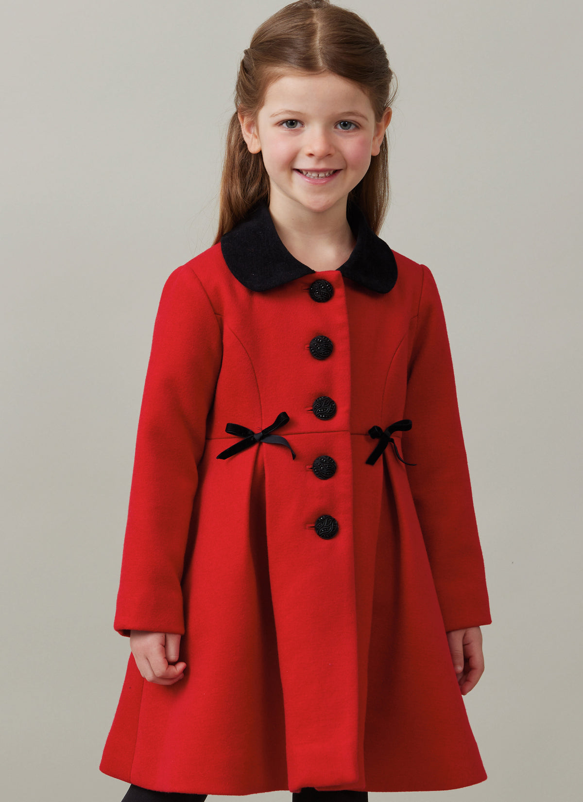Butterick B6921 sewing pattern envelope showing the children's button front coat designs