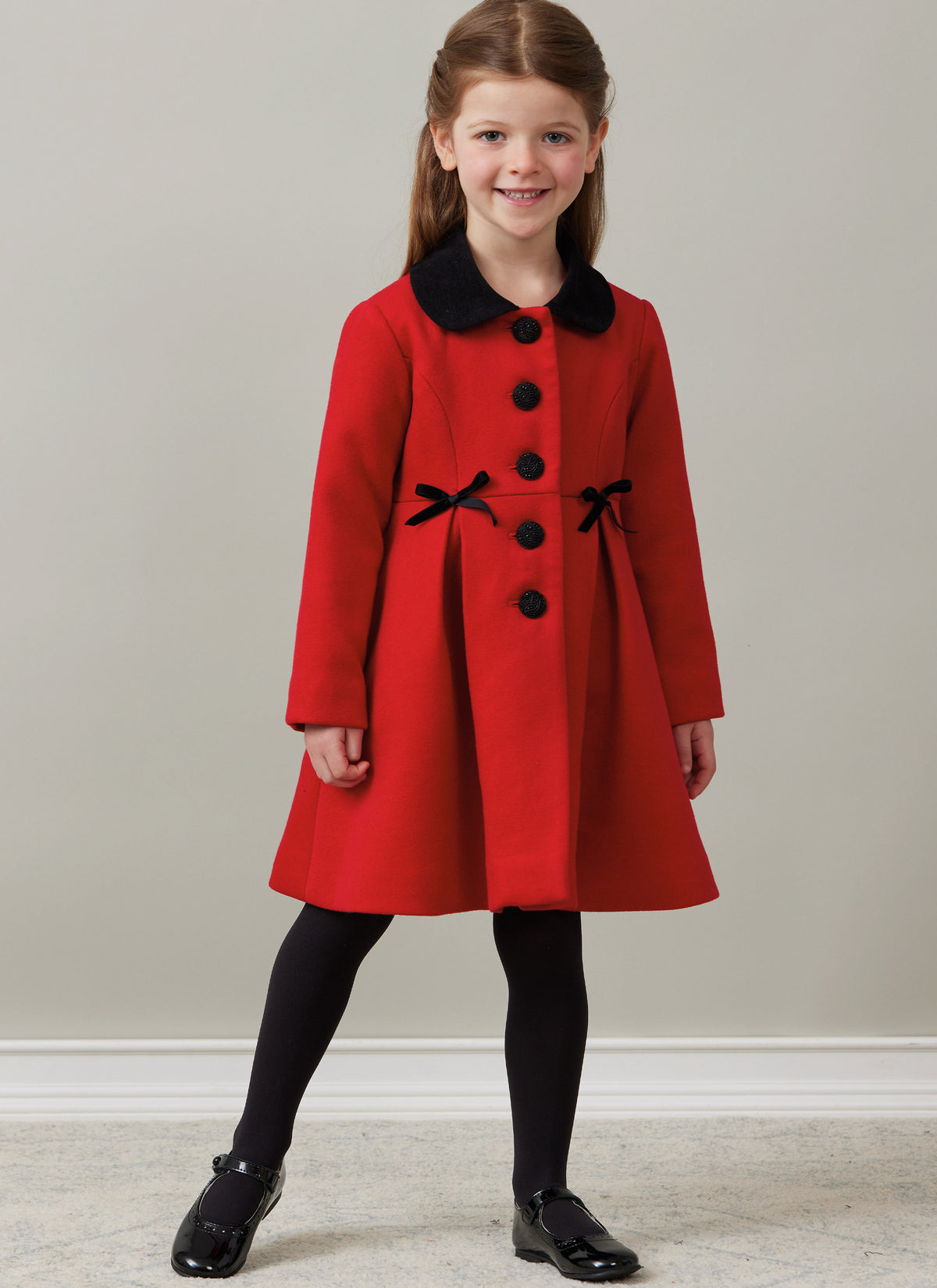 Butterick B6921 sewing pattern envelope showing the children's button front coat designs