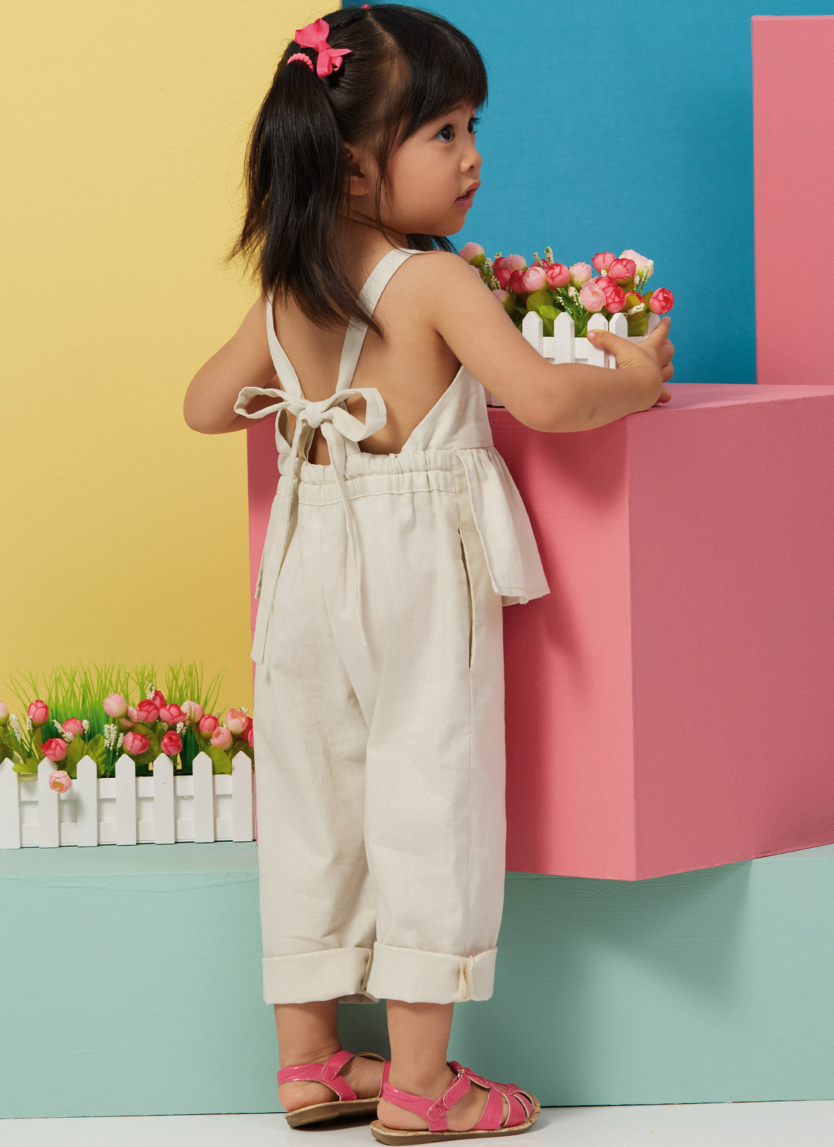Butterick B6936 sewing pattern envelope showing the toddler overalls and dress designs