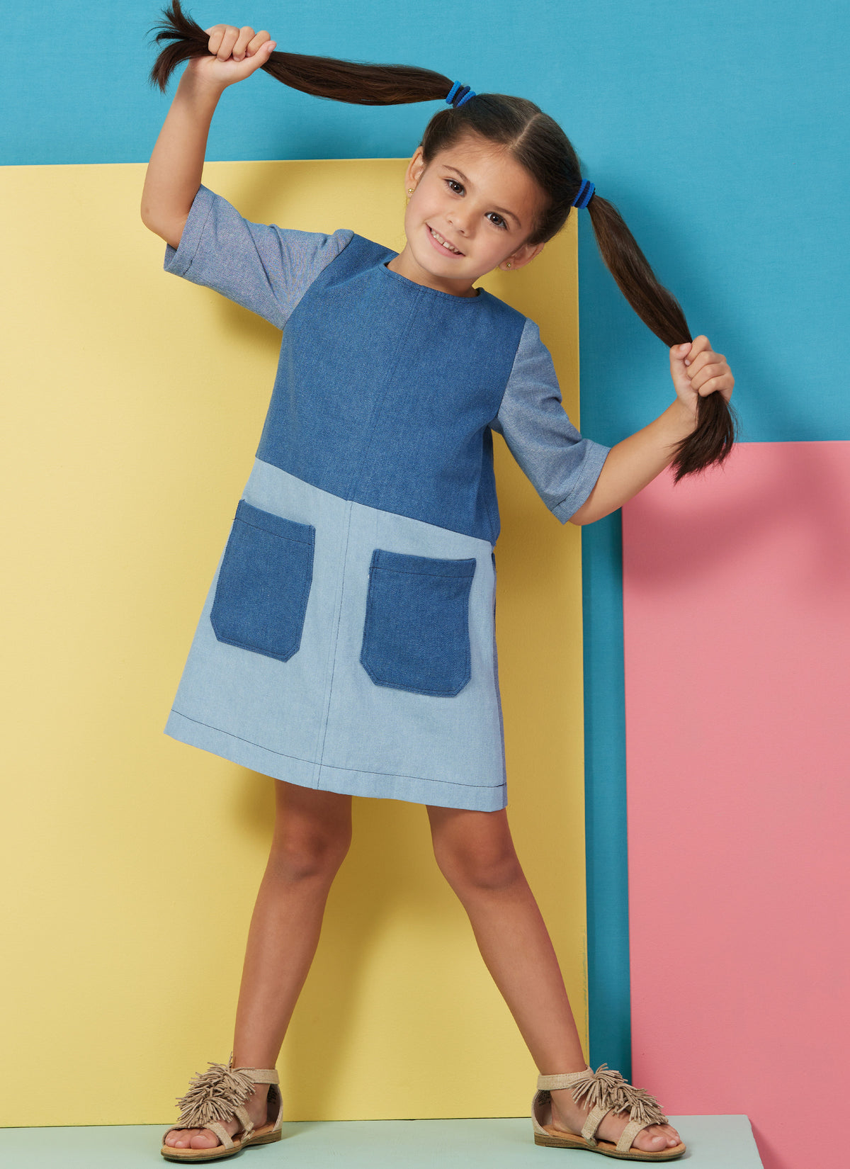 Butterick B6937 sewing pattern envelope showing the children's dress, romper and hat designs