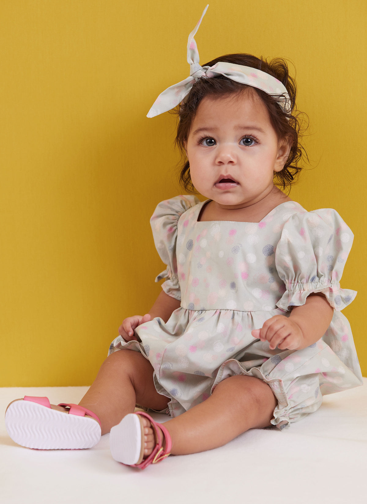Butterick sewing pattern B6950 envelope showing a baby romper in two lengths