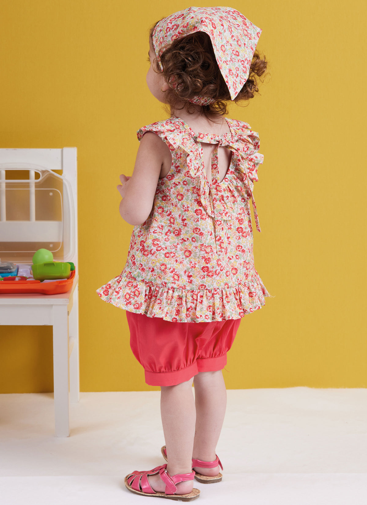 Butterick sewing pattern B6951 envelope showing a toddler's dress and top