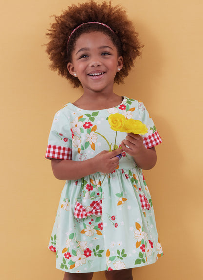 Butterick B6987 sewing pattern envelope showing toddler dresses and rompers