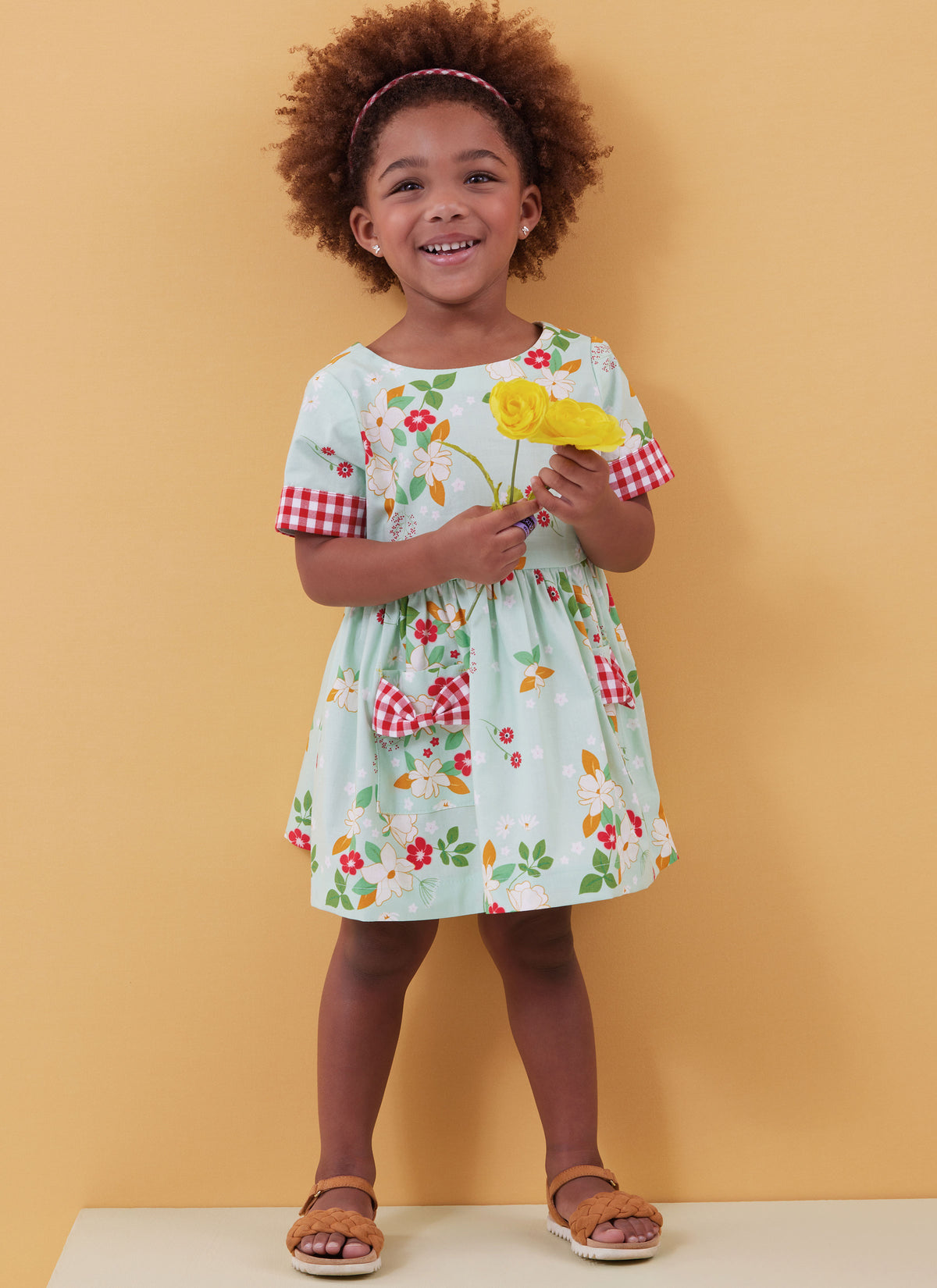 Butterick B6987 sewing pattern envelope showing toddler dresses and rompers