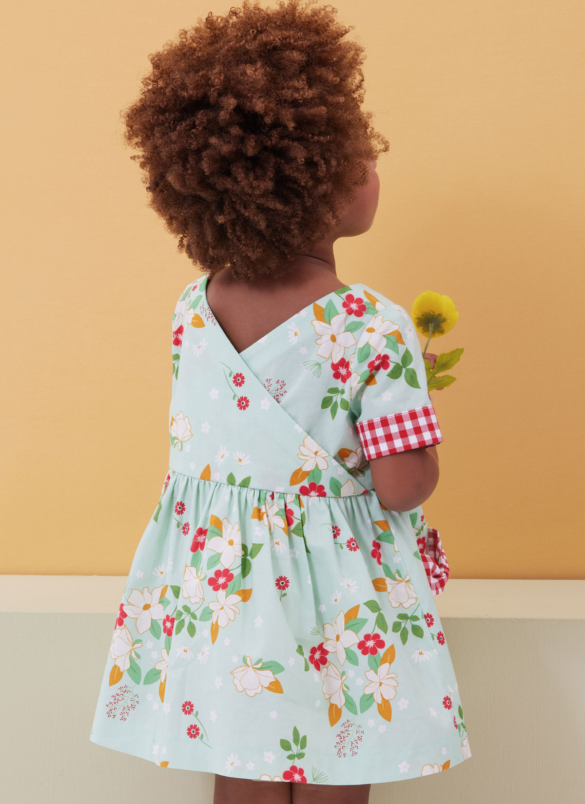 Butterick B6987 sewing pattern envelope showing toddler dresses and rompers
