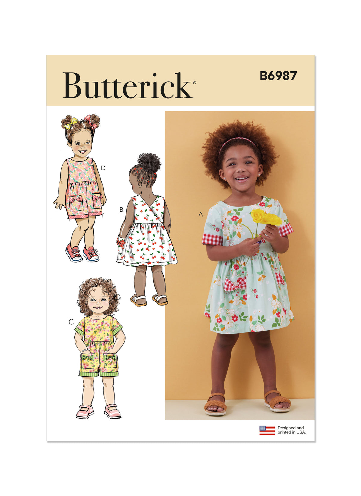 Butterick B6987 sewing pattern envelope showing toddler dresses and rompers