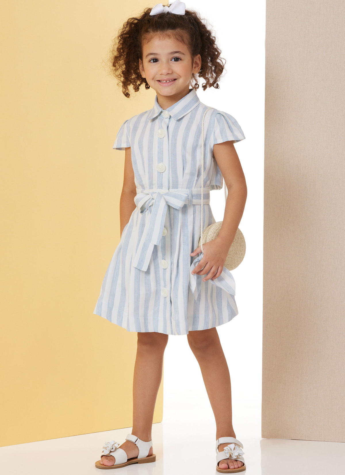 Butterick B7033 sewing pattern envelope showing child's dress designs