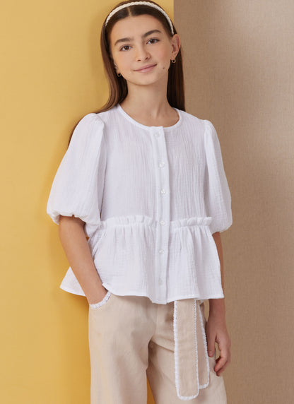 Butterick B7034 sewing pattern envelope showing girls' top designs