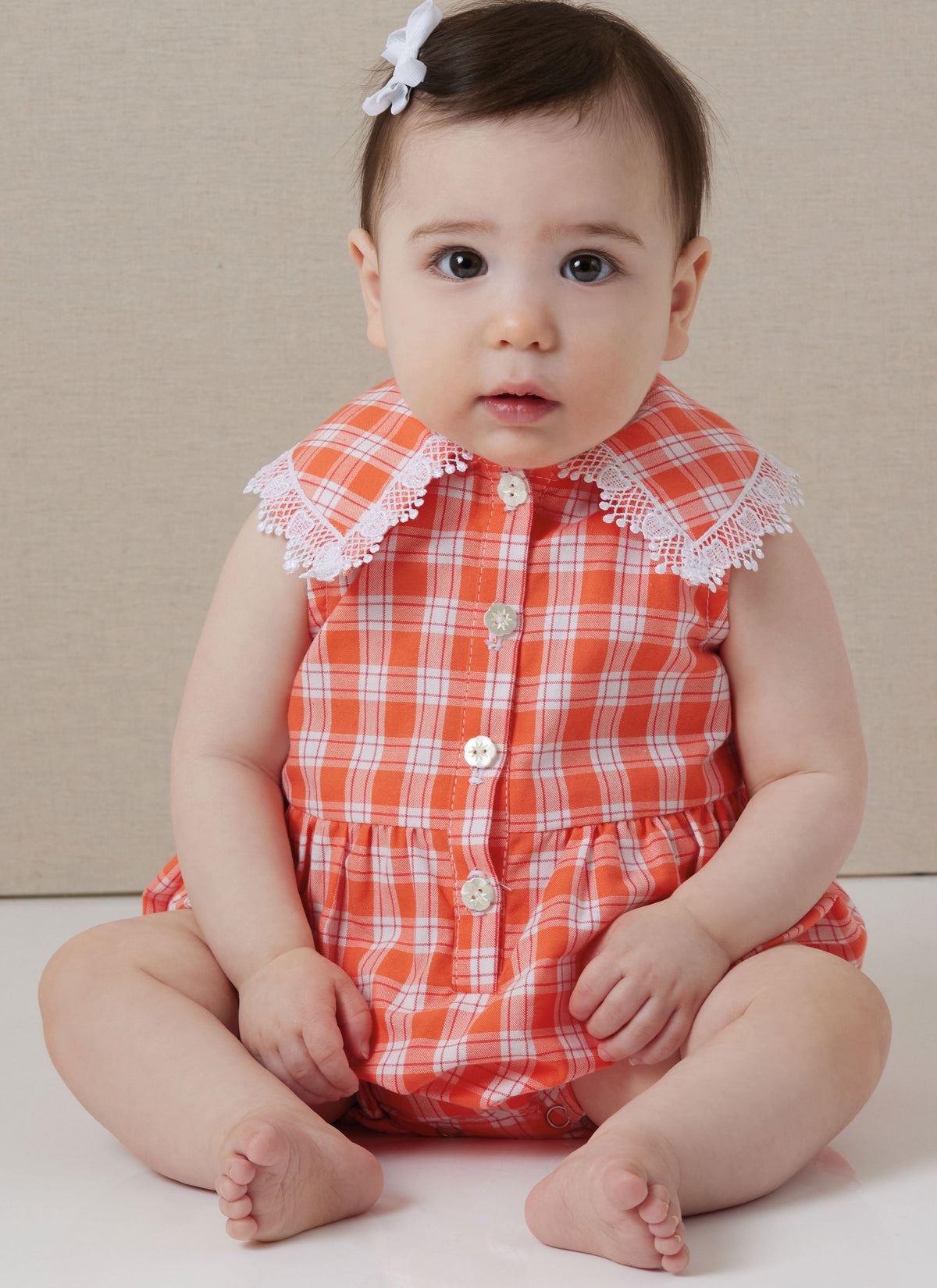 Butterick B7048 sewing pattern envelope showing baby romper designs