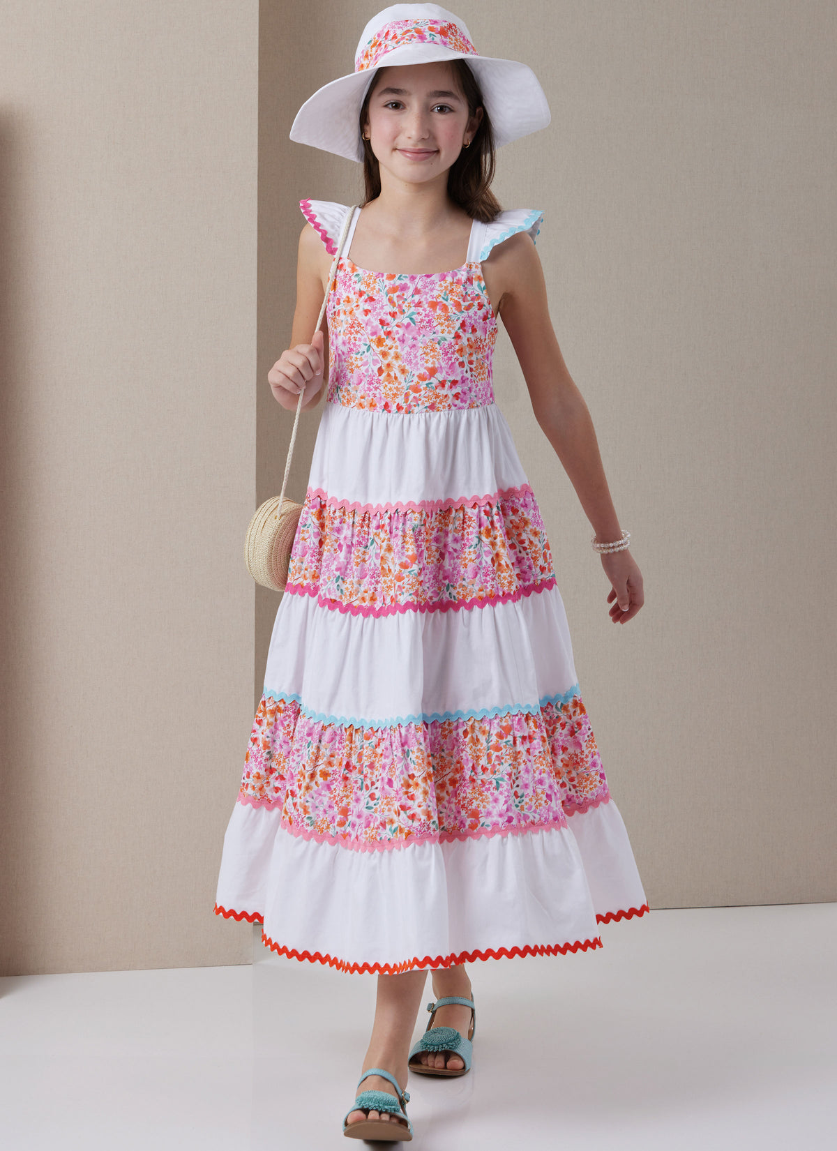 Butterick B7051 sewing pattern envelope showing girls' tiered dress designs