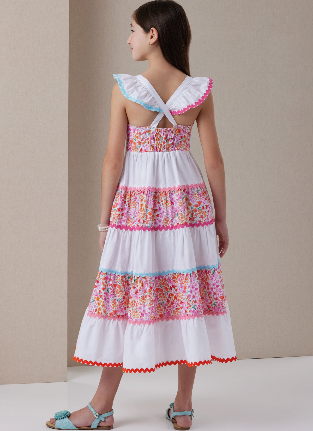 Butterick B7051 sewing pattern envelope showing girls' tiered dress designs