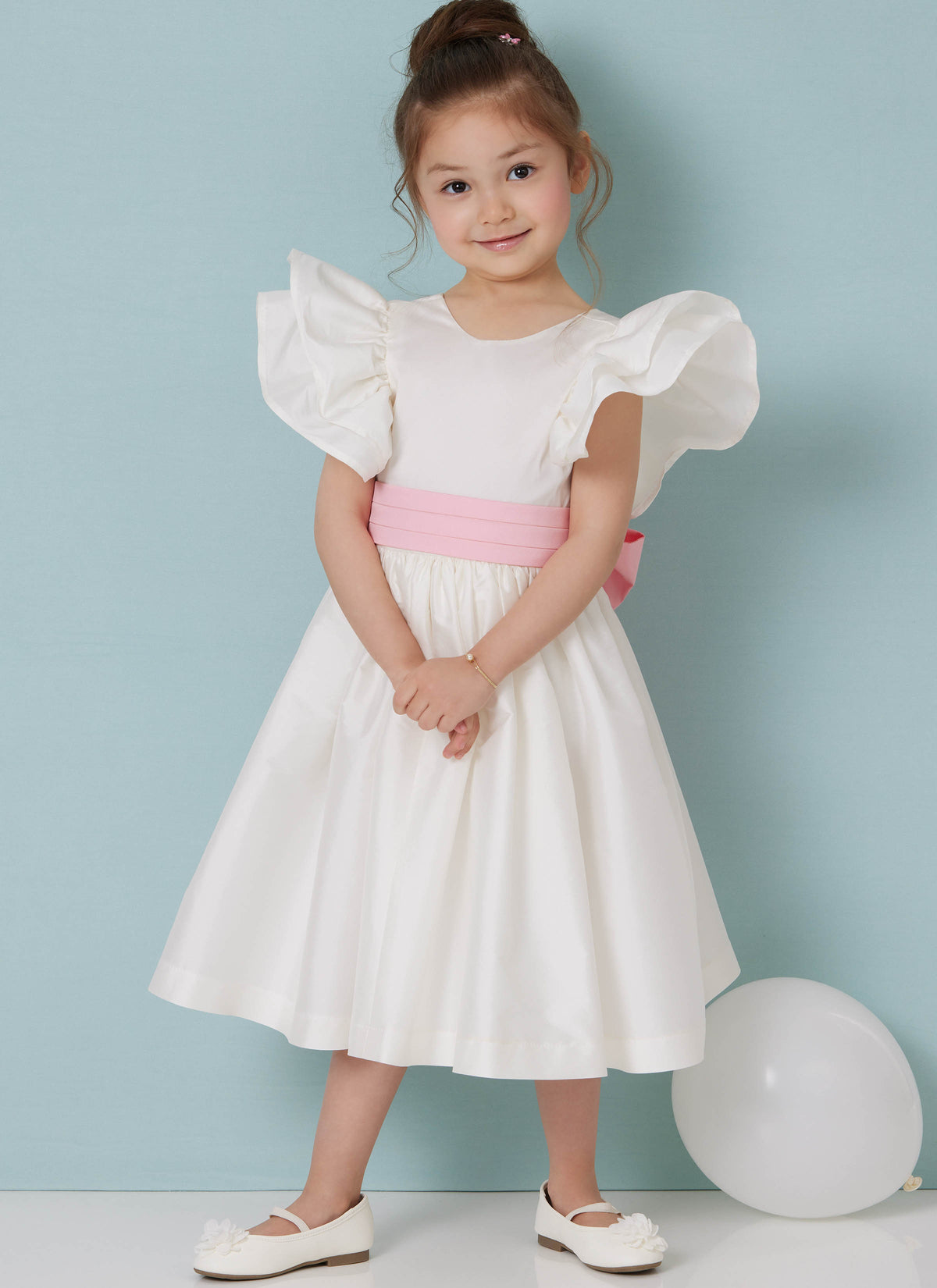 Butterick B7088 sewing pattern envelope showing a girls' dress with layered ruffle sleeves