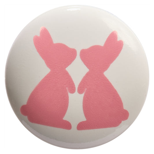 White round button printed with two pink rabbits