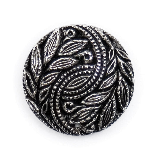 Round silver and black button with a swirling leaf design