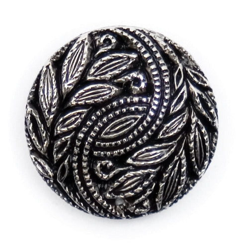 Round silver and black button with a swirling leaf design