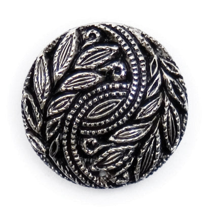 Round silver and black button with a swirling leaf design