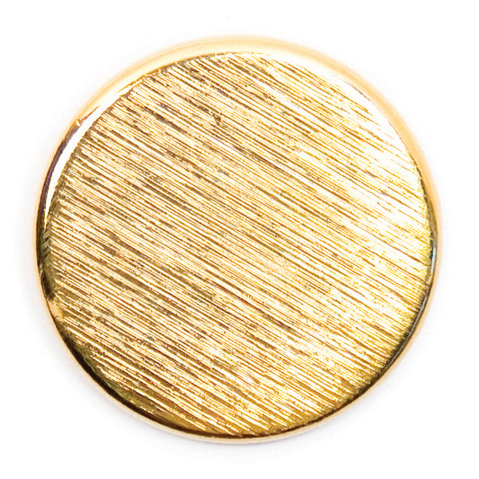 Round gold metal button with a brushed finish