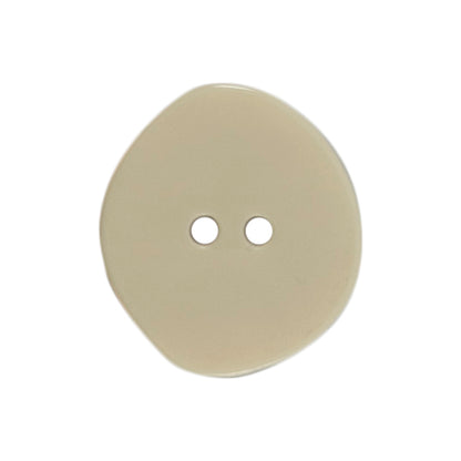 Three 22mm rounded oval off-white buttons with a stone effect on a Milward card