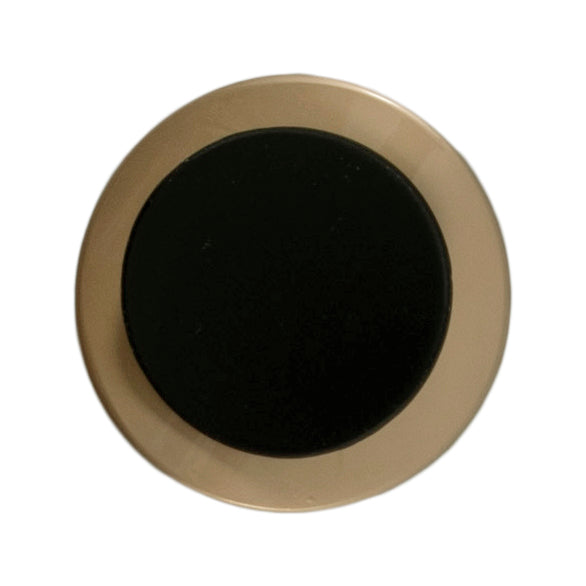Large gold button with a curved black centre on a Milward card