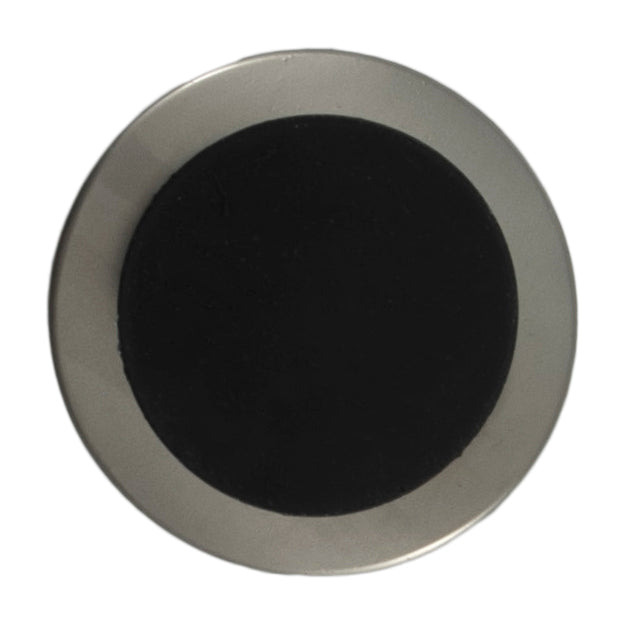 Large silver button with a curved black centre on a Milward card