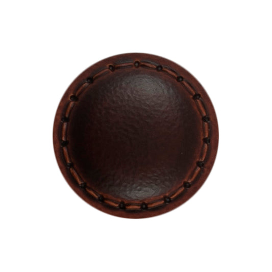 Two light tan imitation leather buttons with stitched rims on a Milward card
