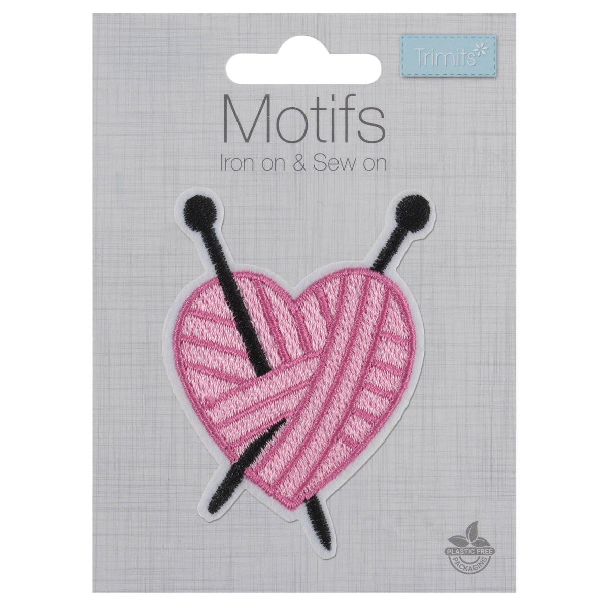 Pink yarn heart motif with black knitting needles