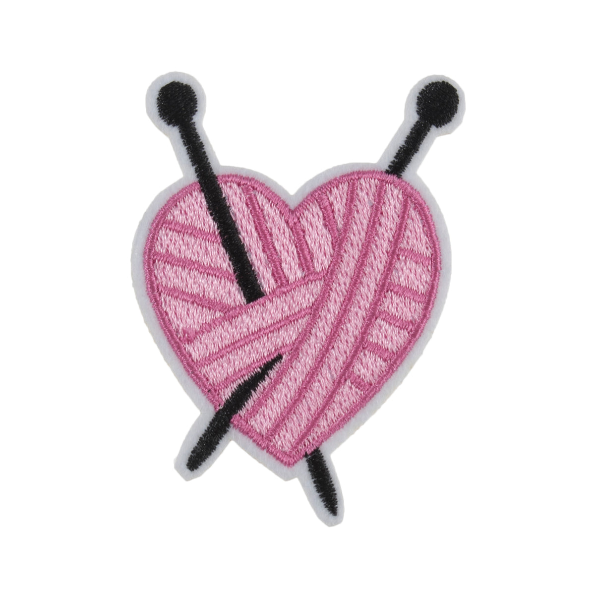 Pink yarn heart motif with black knitting needles