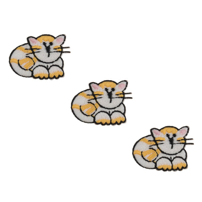 Three small embroidered white and ginger cat motifs