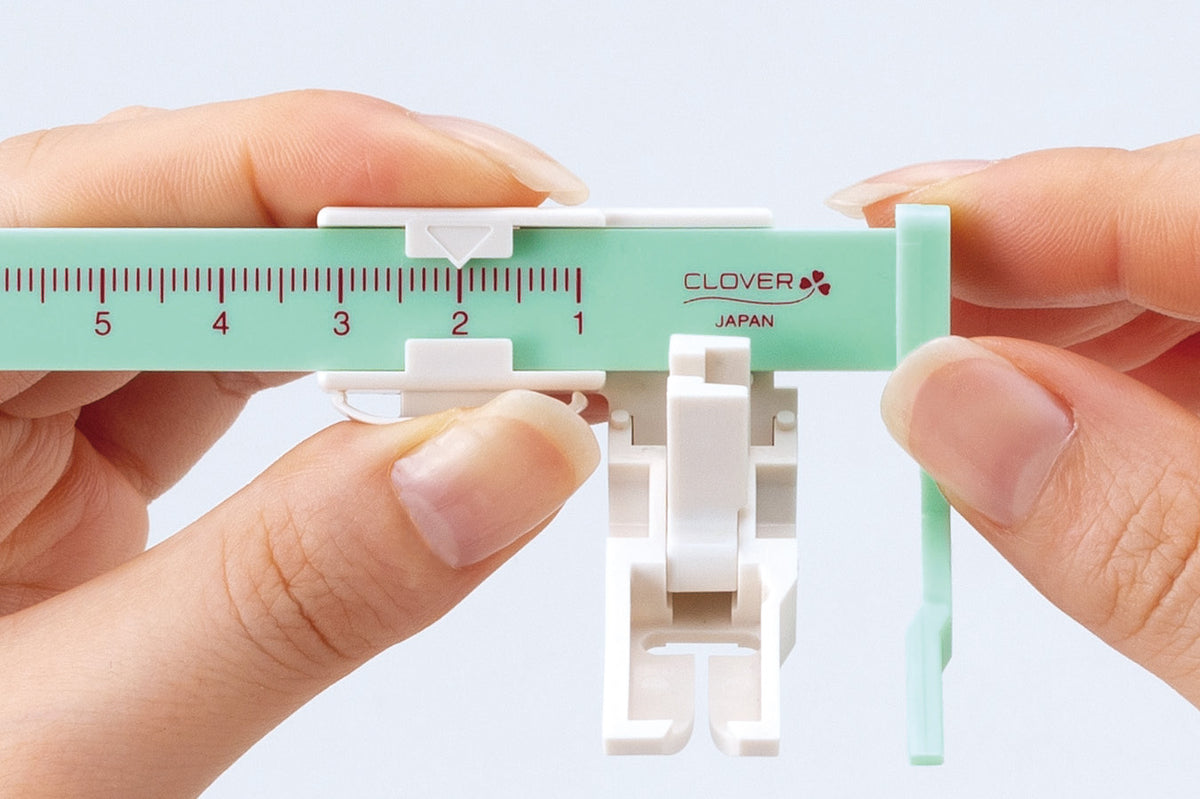 Clover sliding stitch guide presser foot with alignment ruler